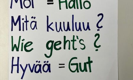 Ein Zettel mit der Überschrift "Finnisch für Anfänger" zeigt vier finnische Wörter mit ihrer deutschen Übersetzung.