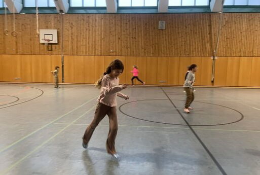Kinder rennen in der Turnhalle